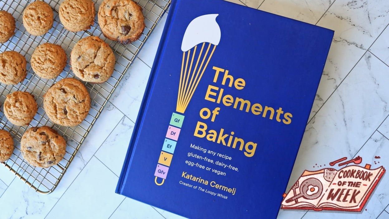 Cookies next to The Elements of Baking cookbook.