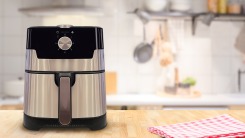 An air fryer on the counter of a kitchen.