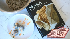 Bollos on a plate next to the Masa cookbook.