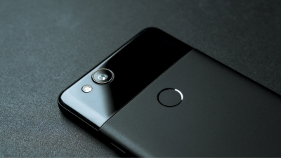 A black pixel phone lying facedown on a black table